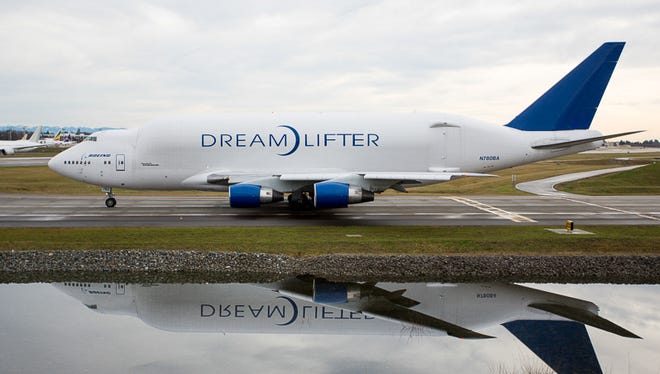 A heavily modified Boeing 747-400 'Dreamlifter' taxies for takeoff from Everett, Wash, on Jan. 6, 2015.