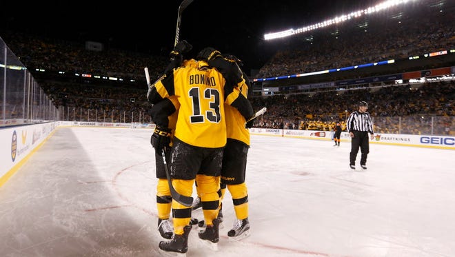 Nick Bonino (13) of the Pittsburgh Penguins is congratulated by his teammates after scoring a goal against the Philadelphia Flyers at Heinz Field.