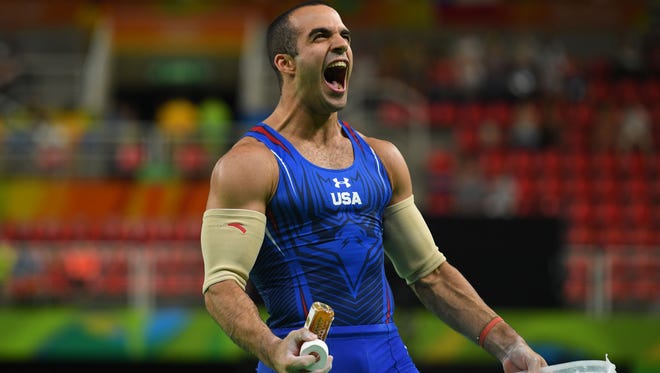 Danell Leyva (USA) reacts after competing during the men's parallel bars final in the Rio 2016 Summer Olympic Games at Rio Olympic Arena.