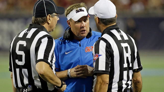 Mississippi head coach Hugh Freeze, center, has words with officials during the first half of an NCAA college football game against Florida State, Monday, Sept. 5, 2016, in Orlando, Fla. (AP Photo/John Raoux)