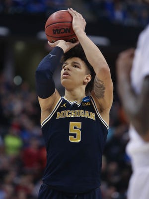 D.J. Wilson hits two free throws in the final seconds to seal Michigan's 73-69 win over Louisville on March 19 at Bankers Life Fieldhouse in Indianapolis in the second round of the 2017 NCAA tournament.