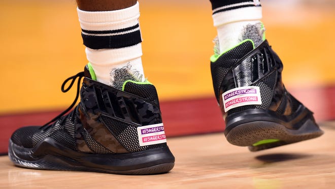 Miami Heat forward Justise Winslow displays two stickers on the back of his basketball sneakers to honor of the late TNT broadcaster Craig Sager during the second half of a game against the Los Angeles Clippers at American Airlines Arena.