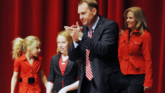 New Mississippi head football coach Hugh Freeze claps as he enters a press conference with his family announcing his hiring at the Ford Center on campus in Oxford, Miss. on Monday, Dec. 5, 2011.