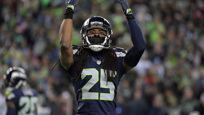 Seattle Seahawks cornerback Richard Sherman (25) rallies the crowd for noise against the Detroit Lions during the first half in the NFC Wild Card playoff football game at CenturyLink Field.