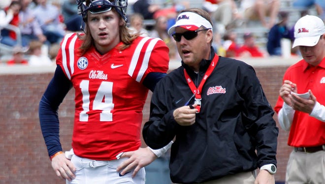 Mississippi quarterback Bo Wallace (14) and football coach Hugh Freeze confer during their NCAA college football spring scrimmage on Saturday, April 5, 2014, in Oxford, Miss. AP Photo/Rogelio V. Solis)
