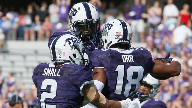 TCU Horned Frogs safety Nick Orr (18) celebrates intercepting a pass with safety Niko Small (2) in the first quarter against the Texas Tech Red Raidersat Amon G. Carter Stadium.