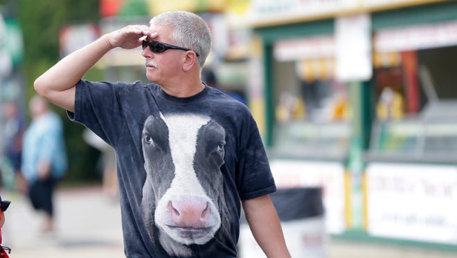 Bob Wilson, from Waterford, dons his cow T-shirt while walking the state fairgrounds.