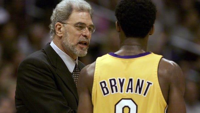 2000: Jackson talks to Kobe Bryant during a win over Seattle at the Staples Center.