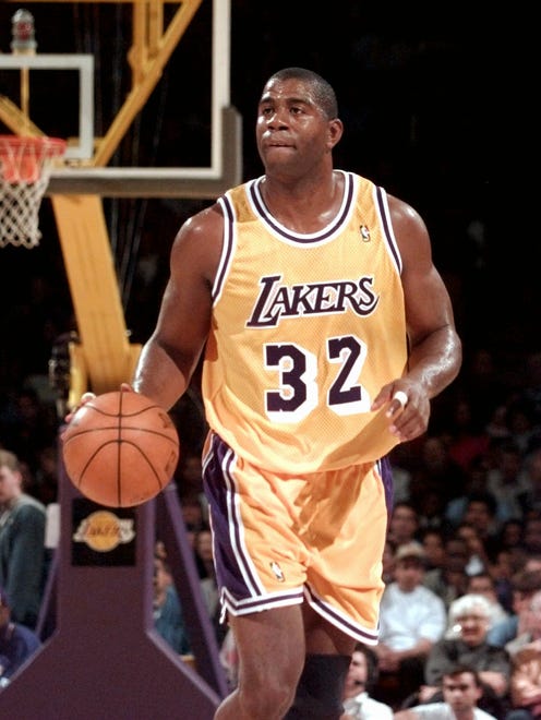 1996: Earvin "Magic" Johnson brings the ball upcourt against Golden State in his first game out of retirement.