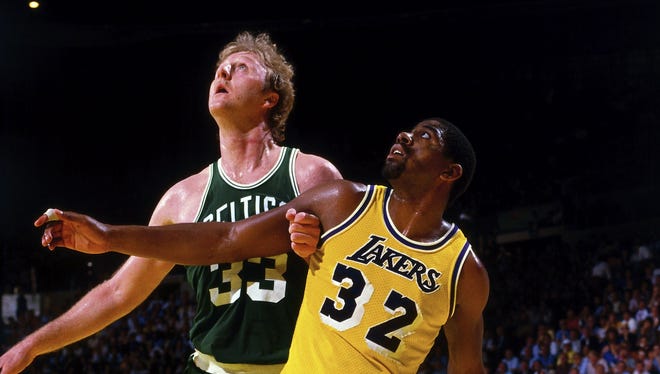 1984: Magic Johnson #32 of the Los Angeles Lakers battles for position against Larry Bird #33 of the Boston Celtics.