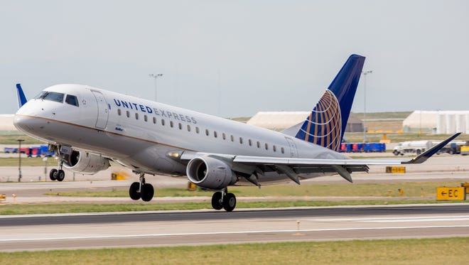 A United Express Embraer E170 teters during a crosswind landing at Denver International Airport on May 7, 2017.