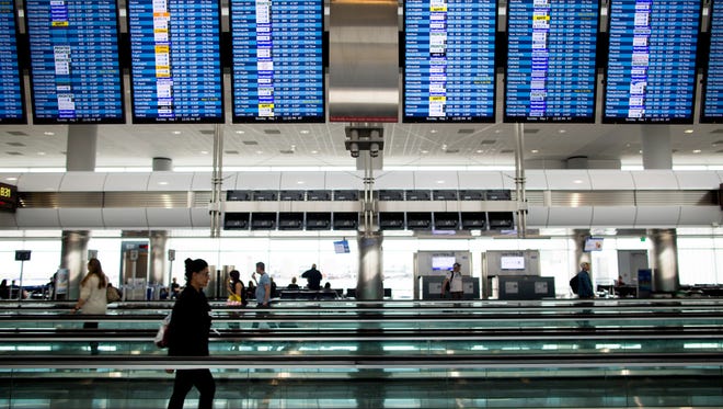Passengers transit through Terminal A at Denver International Airport on May 7, 2017.