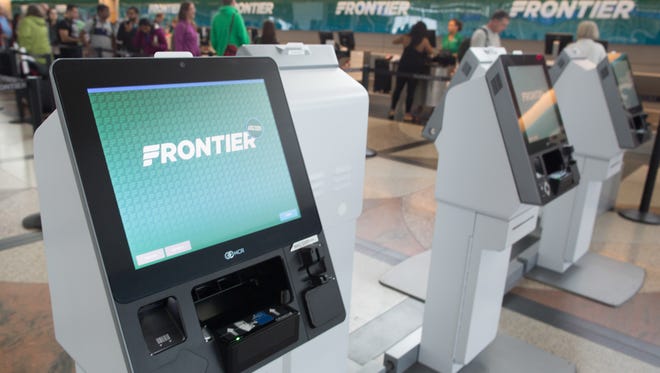 Check-in kiosks with Frontier stand ready for customers at  Denver International Airport on May 7, 2017.