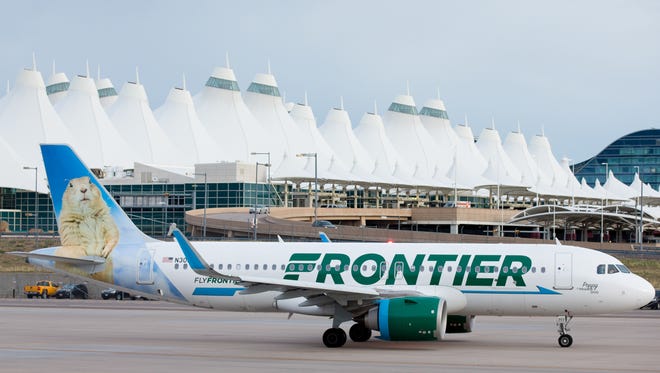A Frontier Airbus A320neo taxies past Denver International Airport's unique central terminal on May 7, 2017.