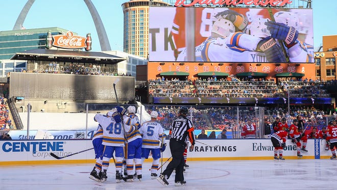 Members of the St. Louis Blues alumni celebrate after scoring a goal against the Chicago Blackhawks during the 2017 NHL Winter Classic alumni game at Busch Stadium.