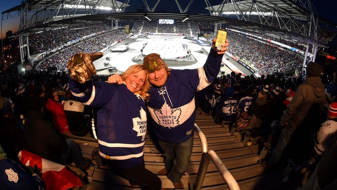Toronto Maple Leafs fans Tammy McLean and Martin Hervieux take in the view from the back of the temporary south end seats during the Centennial Classic ice hockey game at BMO Field. Mandatory Credit: Dan Hamilton-USA TODAY Sports