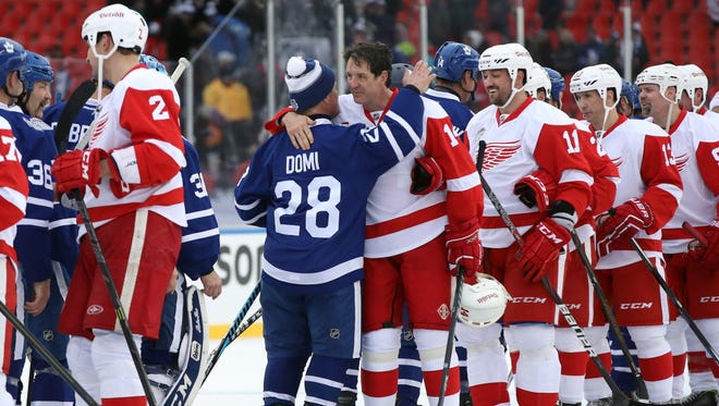 Red Wings forward Brendan Shanahan (14) shares a hug with Maple Leafs forward Tie Domi (28) after the Centennial Classic Alumni Game.