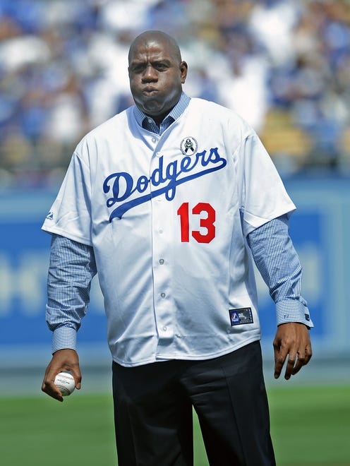 2013: Los Angeles Dodgers owner Magic Johnson gets ready to throw out the first pitch before the game against the San Francisco Giants.