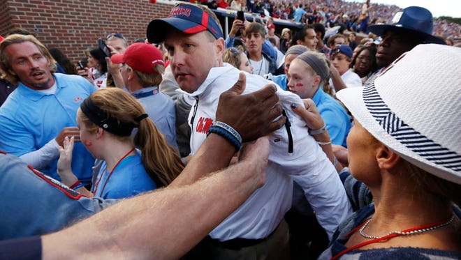 IFLE - In this Oct. 4, 2014, file photo, Mississippi football coach Hugh Freeze is congratulated by fans as he walks off the field after their 23-17 win over No. 3 Alabama in Oxford, Miss. Freeze's three-year tenure at Mississippi has proven at least one thing _ recruiting matters. The Rebels have rocketed from an SEC afterthought to the No. 3 team in the country by bringing in better talent, (AP Photo/Rogelio V. Solis, File)