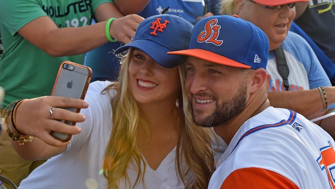 July 6: Tim Tebow takes a selfie picture with a fan prior to the game against the Charlotte Stone Crabs.