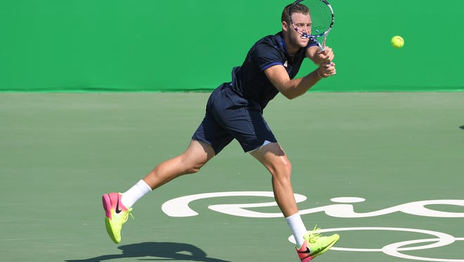 Jack Sock of the United States hits a backhand to Taro Daniel of Japan during the men's singles in the Rio 2016 Summer Olympic Games at Olympic Tennis Centre.