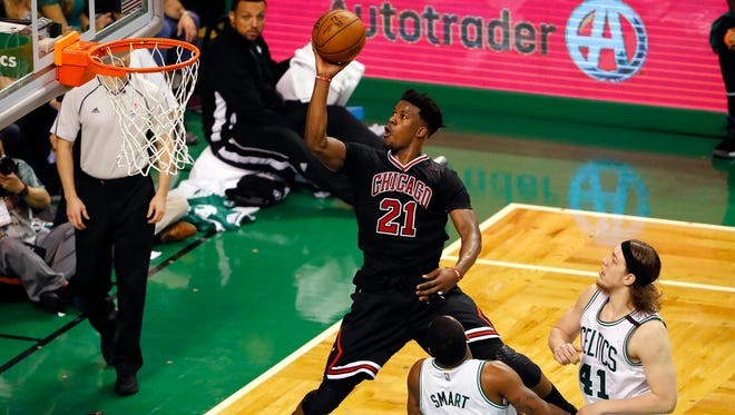 Chicago Bulls forward Jimmy Butler (21) goes to the basket past Boston Celtics guard Marcus Smart (36) and center Kelly Olynyk (41) during the third quarter in game one of the first round of the 2017 NBA Playoffs at TD Garden.