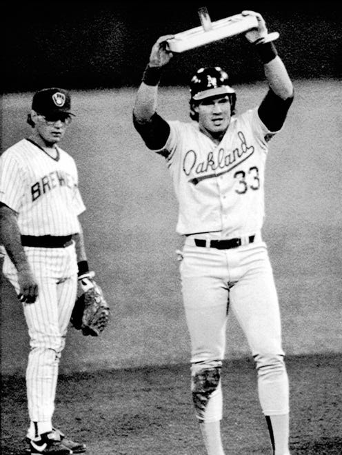 Jose Canseco holds up second base after getting his 40th stolen base of the season. That season he also hits 40 home runs.