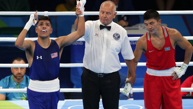 Carlos Zenon Balderas Jr of the United States has his hand raised after beating Berik Abdrakhmanov of Kazhakstan in their men's light preliminary bout at Riocentro - Pavilion 6 during the Rio 2016 Summer Olympic Games.