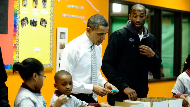 President Barack Obama and Kobe Bryant join children to pack gifts for troops and homeless people at a Boys and Girls Club in Washington on December 13, 2010.
