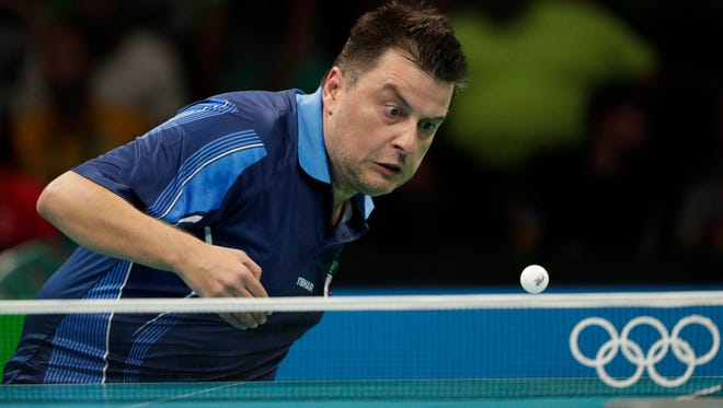 Aleksandar Karakasevic (SRB) returns the ball against Paul Drinkhall (GBR) during round 1 of a table tennis match at Riocentro Pavilion 3 in the Rio 2016 Summer Olympic Games.