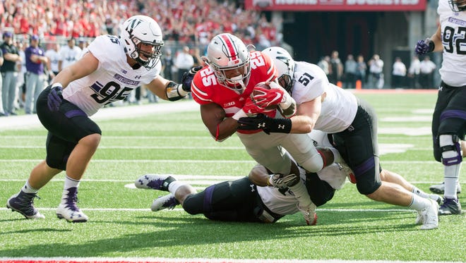 Ohio State Buckeyes running back Mike Weber (25) is stopped short of the goal line by Northwestern Wildcats linebackers Anthony Walker Jr. (1) and Jaylen Prater (51) as defensive lineman Alex Miller (95) closes in during the first quarter at Ohio Stadium.