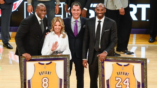2017: Magic Johnson, Jeannie Buss and Rob Pelinka pose with Kobe Bryant during a halftime ceremony retiring Bryant's uniform numbers.