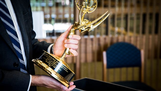 Michael Szajewski, head of archives for Bracken Library at Ball State University, holds one of David Letterman's donated Emmy Awards Friday afternoon. Letterman donated thousands of items from his career to Ball State's archive.