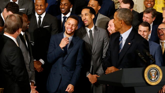 Stephen Curry laughs with teammates as President Barack Obama speaks during a ceremony honoring the 2015 NBA champion Warriors in the East Room at the White House.