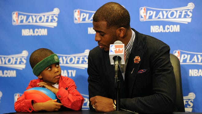 2014: Chris Paul and his son Chris Paul II attend a post game press conference.