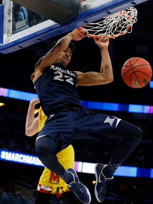 Xavier Musketeers forward Kaiser Gates (22) dunks against Maryland Terrapins guard Kevin Huerter (4) during the second half in the first round of the NCAA Tournament at Amway Center.
