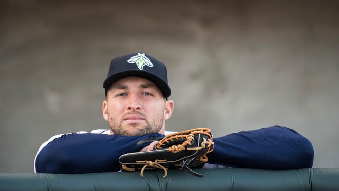 April 6: Tim Tebow looks out from the dugout.