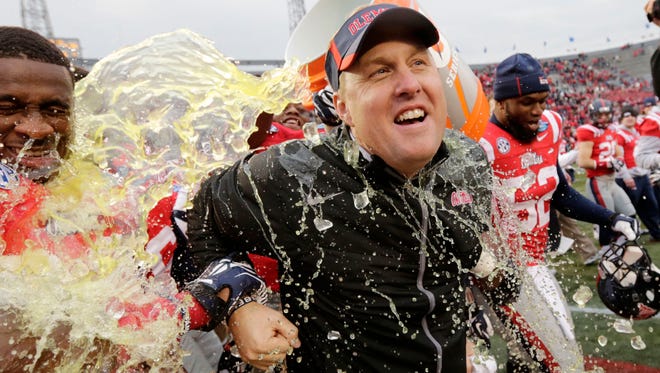 Mississippi head coach Hugh Freeze gets dunked after their 38-17 win over Pittsburgh in the BBVA Compass Bowl NCAA college football game against Pittsburgh at Legion Field in Birmingham, Ala., Saturday, Jan. 5, 2013. (AP Photo/Dave Martin)