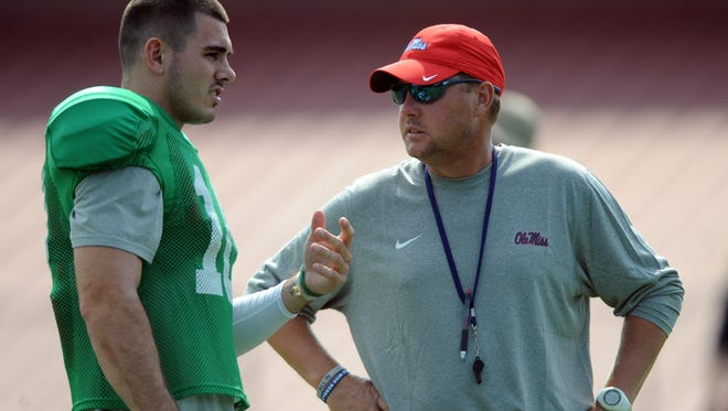 In this Aug. 10, 2015, file photo, Mississippi quarterback Chad Kelly, left, talks with head coach Hugh Freeze during NCAA college football practice in Oxford, Miss. Freeze made a surprise choice to protect the team’s most valuable asset. Junior Rod Taylor will be the starter at left tackle when No. 11 Ole Miss plays No. 4 Florida State on Monday, Sept. 5, 2016, in Orlando, Florida. That means the 6-foot-3, 329-pounder _ who has never made a start at either tackle spot _ will be charged with protecting quarterback Chad Kelly’s blindside against the Seminoles’ talented defense. (Bruce Newman/The Oxford Eagle via AP, File)