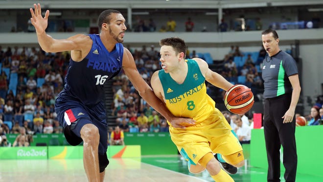 Australia point guard Matthew Dellavedova (8) drives to the basket against France center Rudy Gobert (16) during the second half in the men's basketball group A preliminary round during the during the Rio 2016 Summer Olympic Games at Carioca Arena 1.