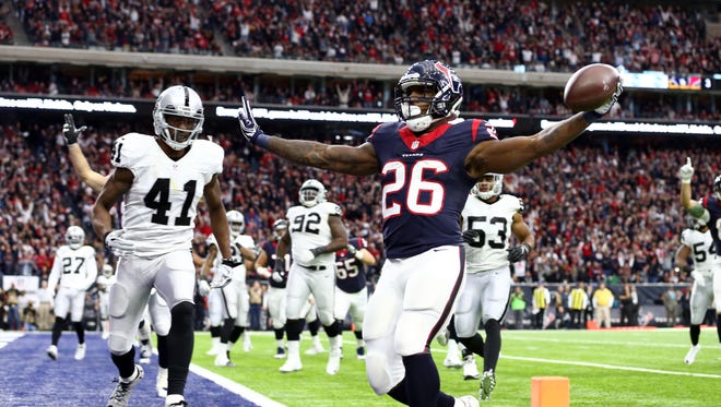 Houston Texans running back Lamar Miller (26) scores a touchdown during the first half in the AFC Wild Card playoff football game against the Oakland Raiders at NRG Stadium.