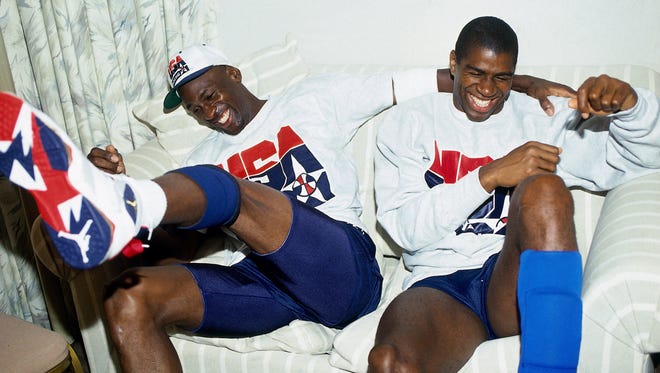 1992: Michael Jordan and Magic Johnson of the United States Basketball Team share a laugh during the 1992 Olympics.