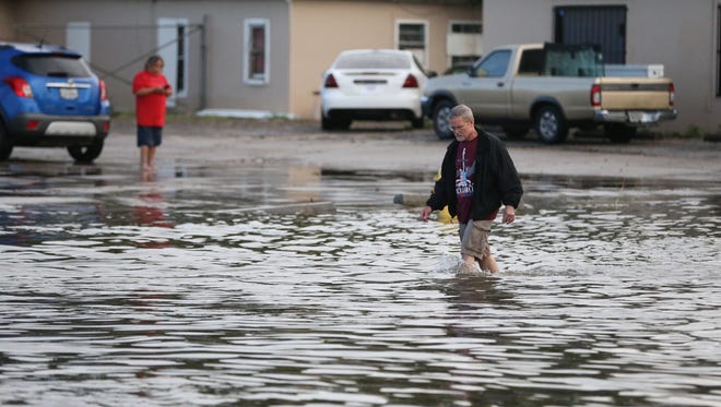 A man walks through the water on Kostoryz Road on Monday, May 16, 2016 in Corpus Christi, Texas. Thunderstorms in South Texas that dumped up to a foot of rain have led to flood-related rescues in Corpus Christi and sewage spilled into a creek.(Rachel Denny Clow/Corpus Christi Caller-Times via AP) ORG XMIT: TXCOR106