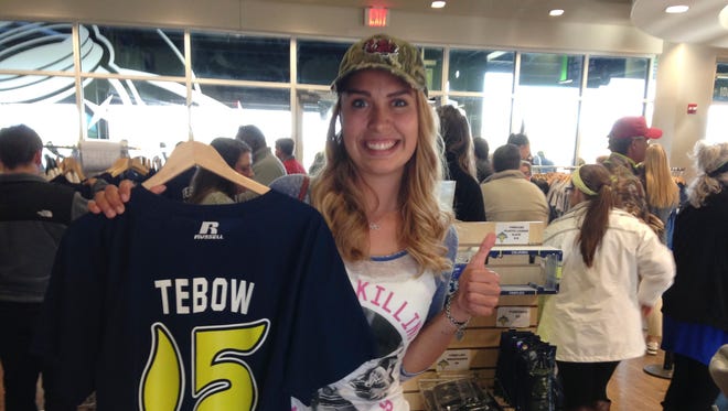 April 6: Noelle Colligan shows off the Tim Tebow jersey she bought just before Tebow's professional baseball debut with the Class A Columbia Fireflies in Columbia, S.C.