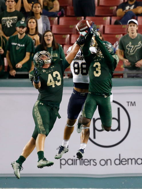 South Florida linebacker Auggie Sanchez (43) and cornerback Deatrick Nichols (3) break up a pass intended for Navy wide receiver Tyler Carmona (88) in the second half.