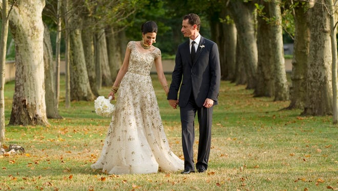 Anthony Weiner walks with his wife, Huma Abedin, for a formal wedding portrait at the Oheka Castle in Huntington, N.Y., on July 10, 2010.