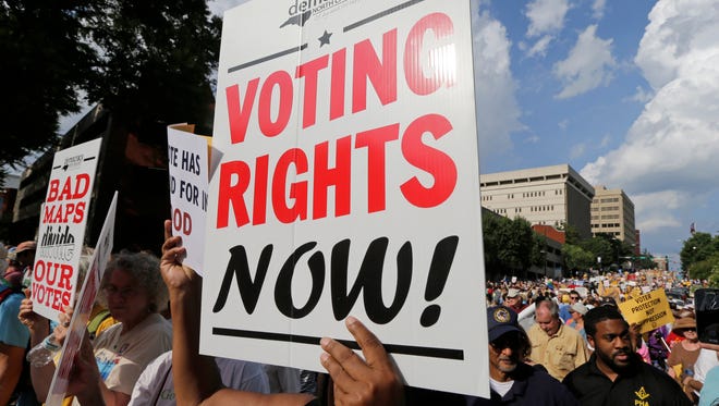 Demonstrators marched through the streets of Winston-Salem, N.C., last July during a federal voting rights trial challenging a 2013 state law.
