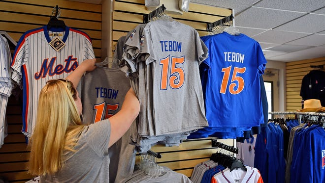 June 27: A fan looks through t-shirts of Tim Tebow in the souvenir shop at First Data Field.