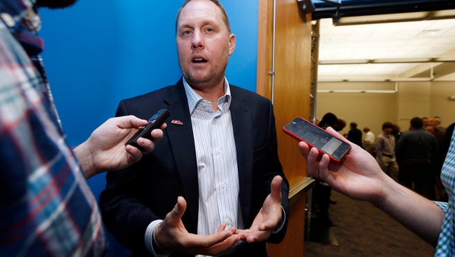 Mississippi football coach Hugh Freeze discusses his new contract with the media prior to the Conerly Trophy awards ceremony to honor the top college football player at a Mississippi college or university on Tuesday, Dec. 2, 2014, in Jackson, Miss. (AP Photo/Rogelio V. Solis)