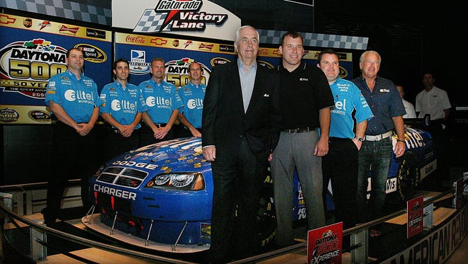 From left, Roger Penske, driver Ryan Newman, crew chief Roy McCauley and Greg Newman, Ryan's father, and the team pose with their Daytona 500 winning car in 2008.